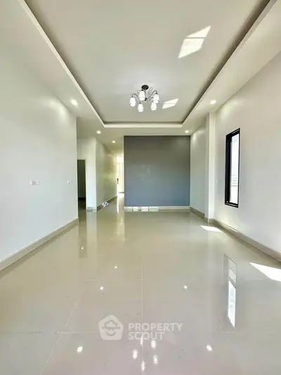 Spacious modern living room with elegant lighting and glossy tiled flooring