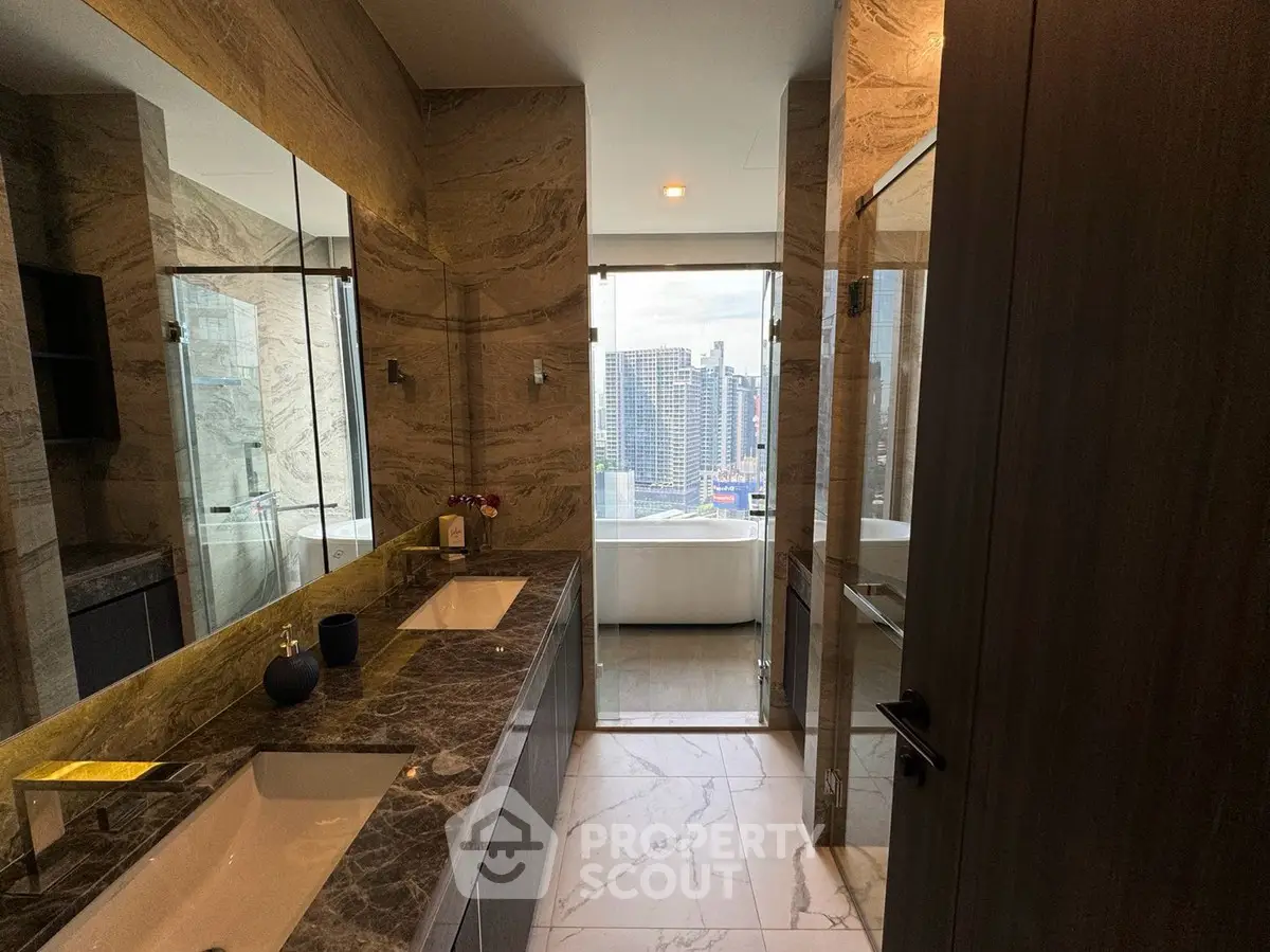 Luxurious bathroom with marble finishes and city view from window