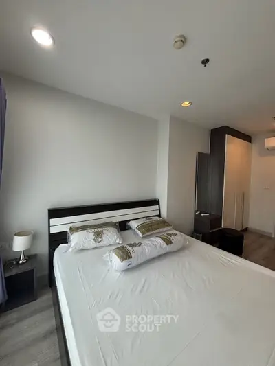 Spacious bedroom with modern decor and ample natural light