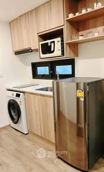 Modern kitchen with sleek appliances and wooden cabinetry