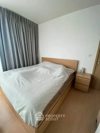 Cozy bedroom with modern wooden furniture and soft lighting, perfect for relaxation.