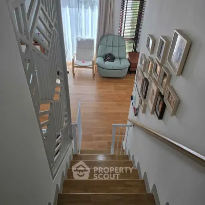 Stylish staircase leading to a cozy living area with modern decor and natural light.