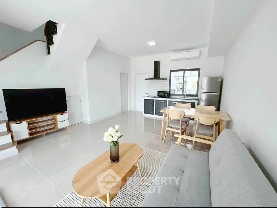 Modern open-plan living room with sleek kitchen and stylish furniture