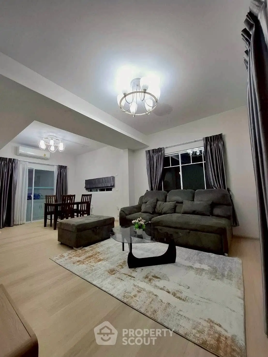 Spacious living room with modern furniture and elegant lighting