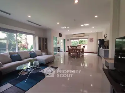 Spacious living room with modern furniture and large windows for natural light.