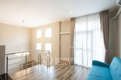Bright and airy living space with modern decor and large windows in a stylish apartment.