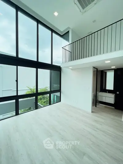 Stunning modern duplex with floor-to-ceiling windows and sleek interior design.