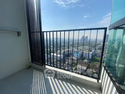 Stunning high-rise balcony with panoramic city view and sleek railing design.