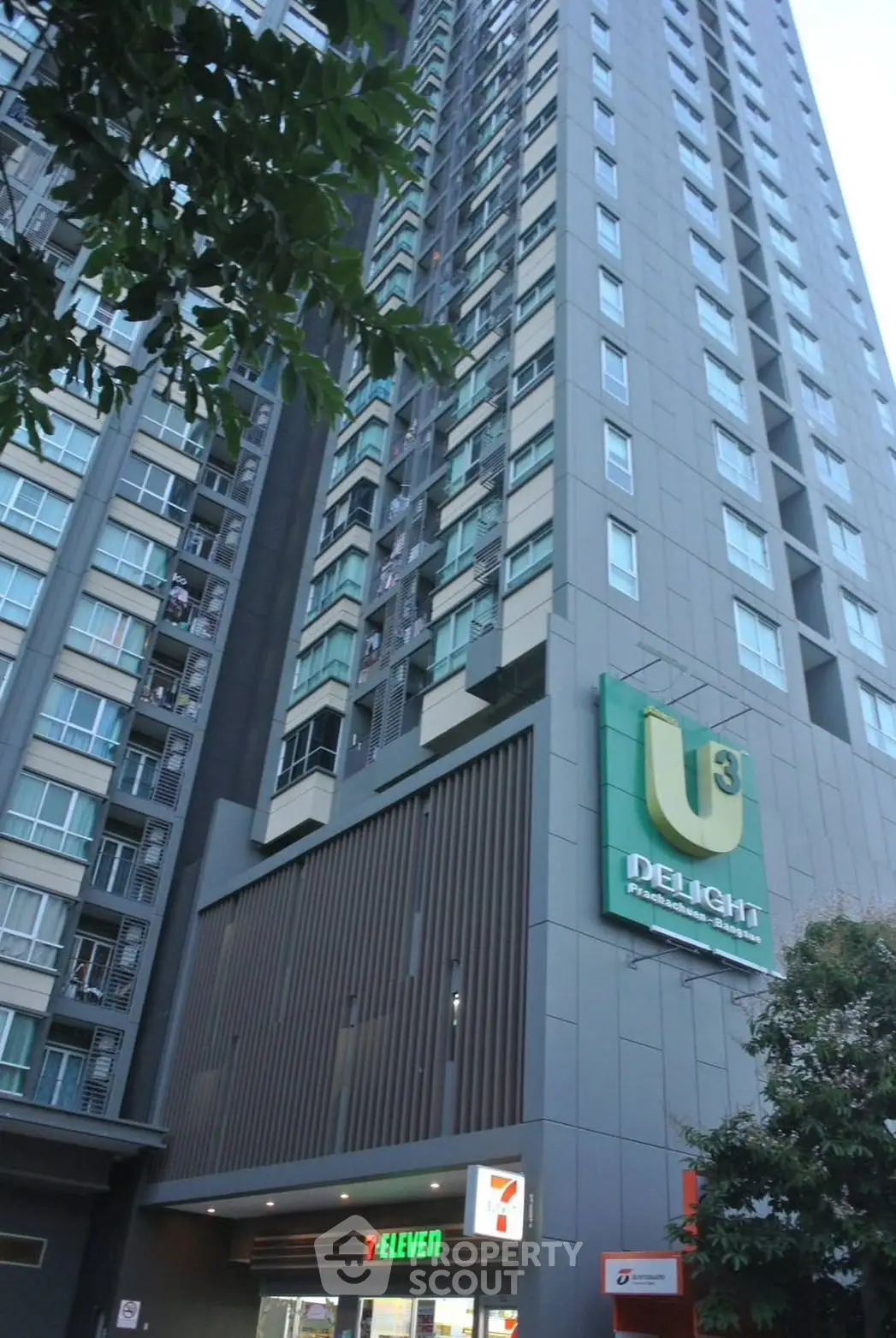 Modern high-rise building with retail space, featuring sleek design and urban convenience.