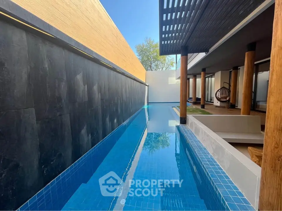 Luxurious modern poolside with sleek design and wooden accents, perfect for relaxation and entertainment.