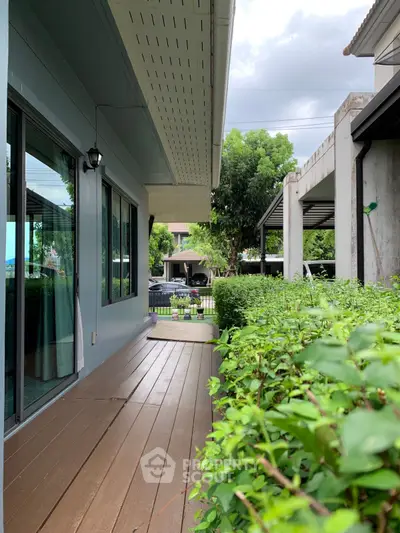 Charming garden view from a modern home with lush greenery and sleek architecture.