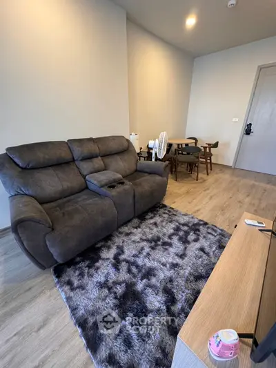 Modern living room with plush sofa and stylish dining area, perfect for cozy gatherings.