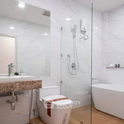 Modern bathroom with glass shower and freestanding bathtub