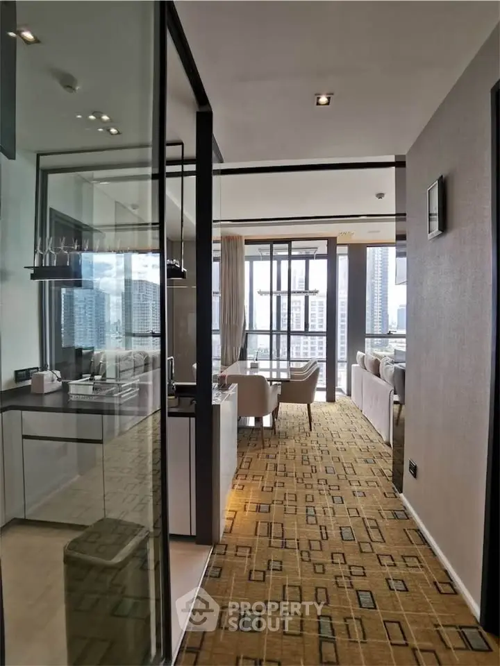 Modern apartment interior with open layout and city view, featuring stylish kitchen and living area.