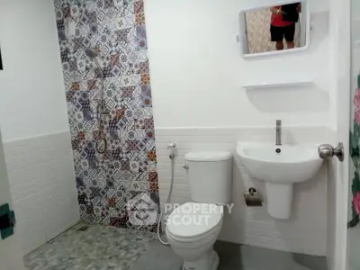 Modern bathroom with stylish tile design and compact fixtures