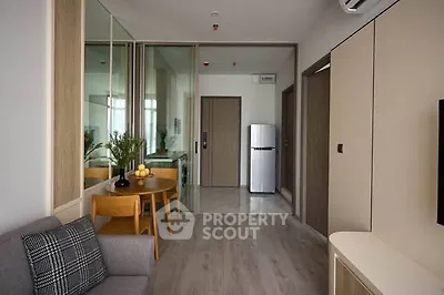 Modern apartment interior with sleek design and compact kitchen area.