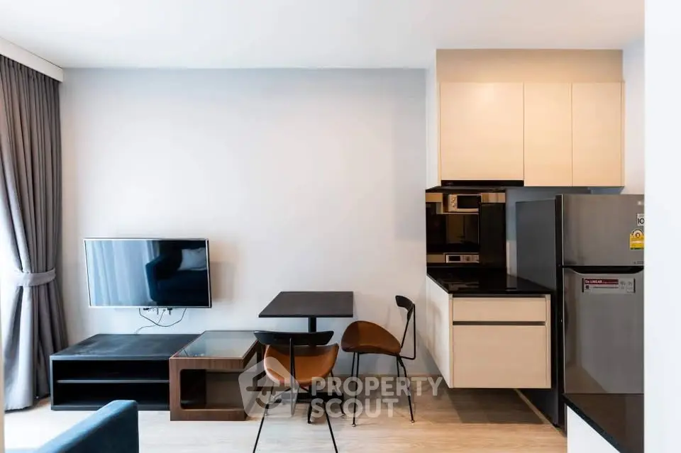 Modern living room with sleek kitchen and stylish furniture