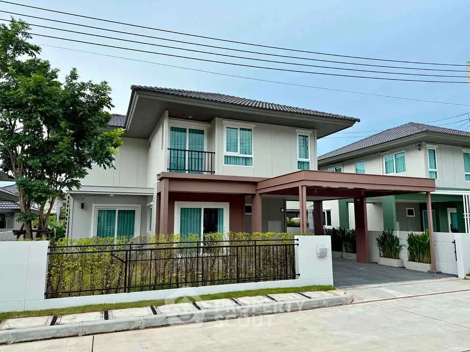 Modern two-story house with sleek design and spacious driveway in a serene neighborhood.