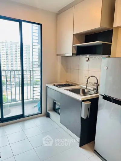 Modern kitchen with balcony view in high-rise apartment