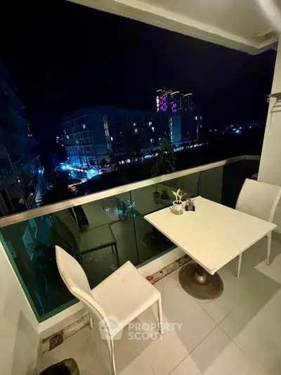 Charming balcony with night city view, perfect for relaxing evenings.