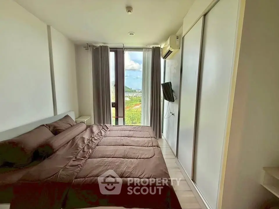 Modern bedroom with large window and scenic view, featuring sleek design and cozy atmosphere.