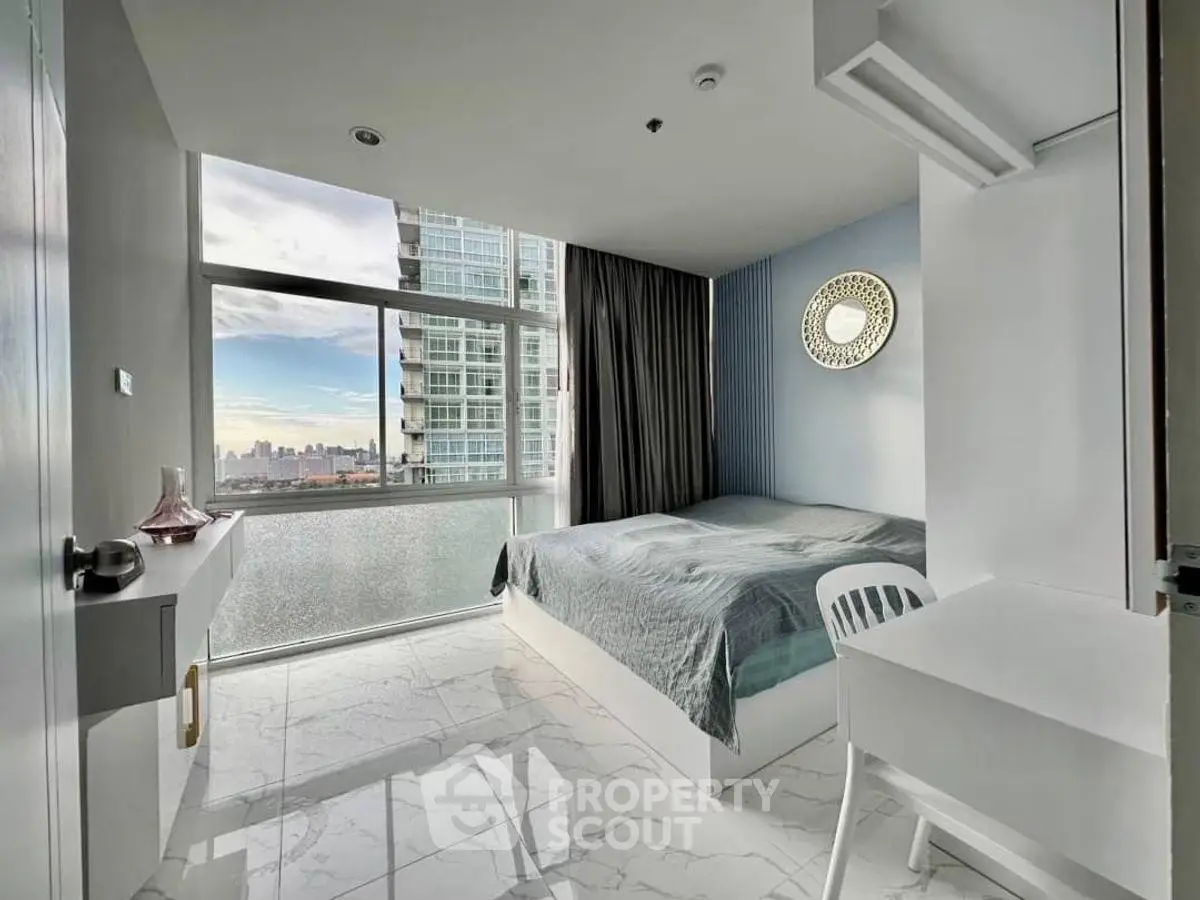 Modern bedroom with city view and sleek furnishings in high-rise apartment