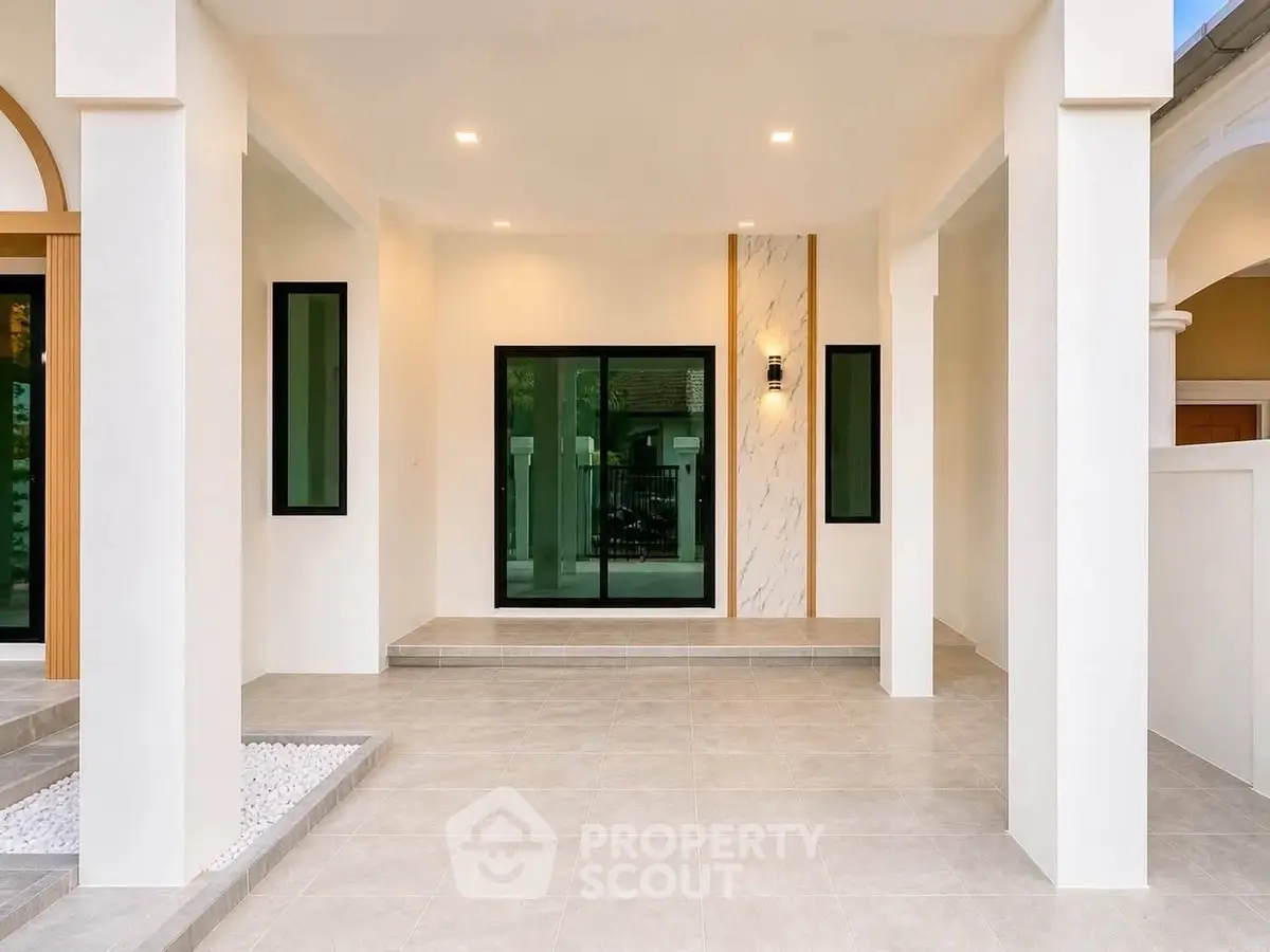 Modern minimalist home entrance with sleek design and large glass doors