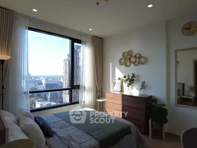 Modern bedroom with large window offering stunning city view
