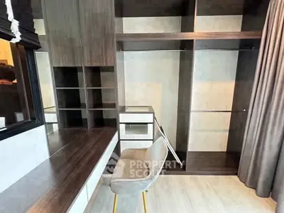 Spacious walk-in closet with modern shelving and elegant chair