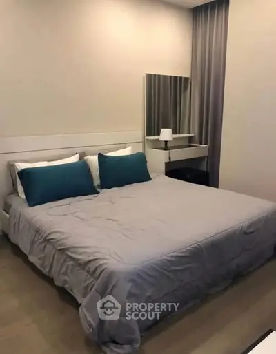 Cozy bedroom with modern decor and stylish bedding in a serene setting.