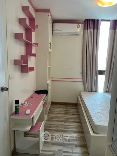 Charming small bedroom with built-in storage and air conditioning, perfect for cozy living.