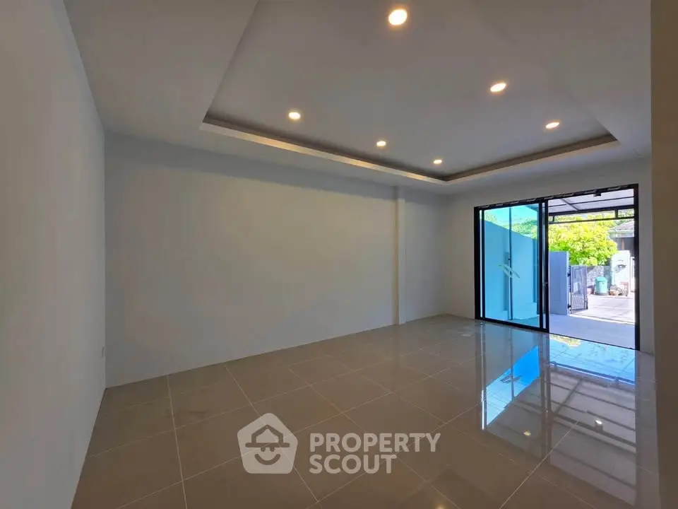 Spacious modern living room with large windows and recessed lighting