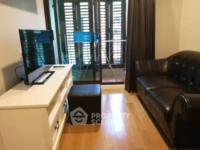 Cozy living room with modern furniture and balcony access in urban apartment.