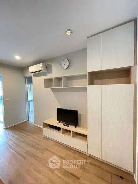 Modern living room with built-in storage and wooden flooring