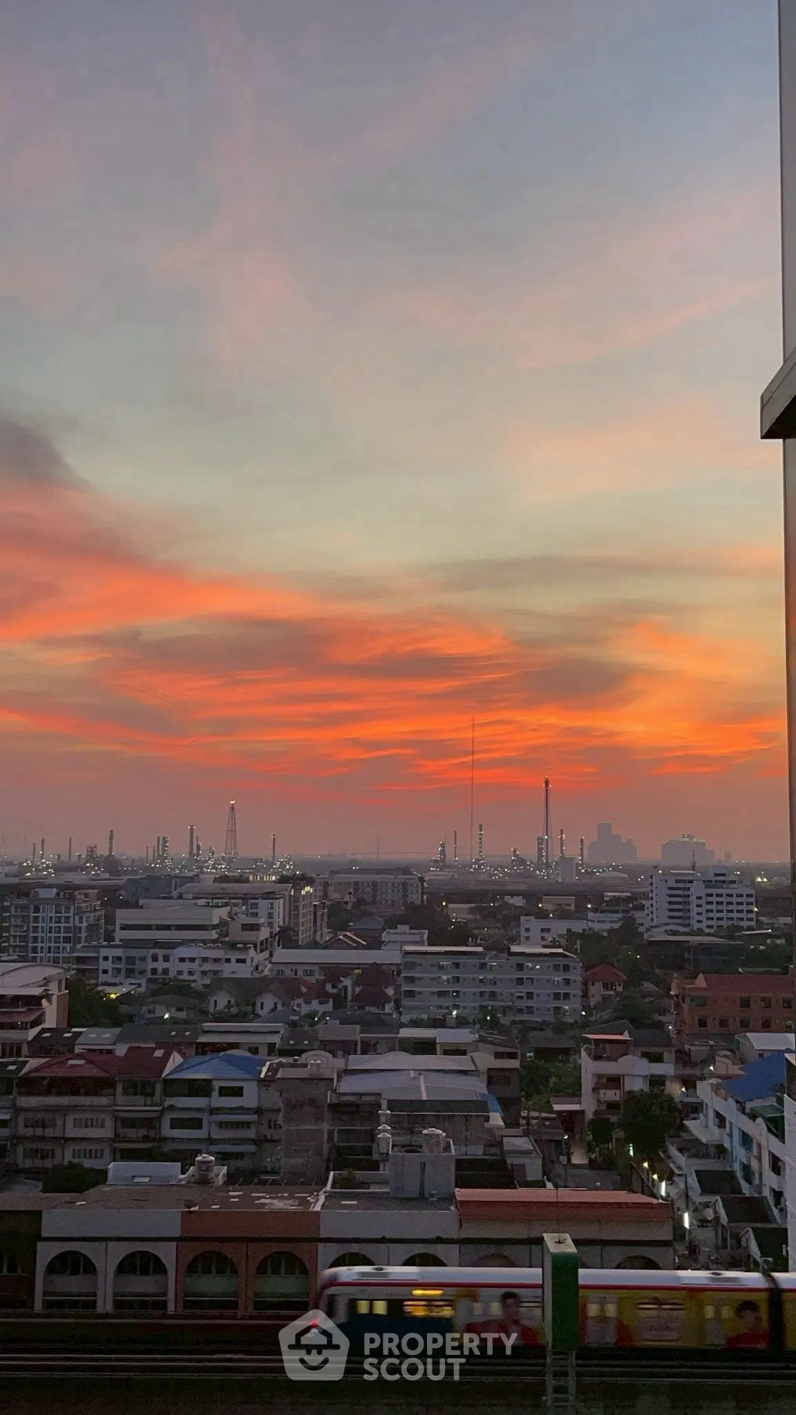 Stunning cityscape view at sunset with vibrant sky over urban skyline.