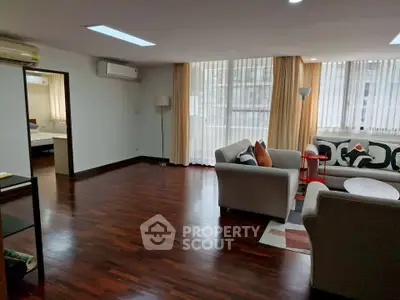 Spacious living room with elegant hardwood floors and modern furniture