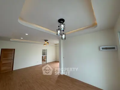Spacious modern living room with elegant lighting and wooden flooring