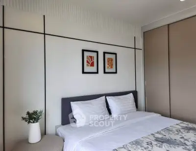 Modern bedroom with stylish decor and cozy bedding in a contemporary apartment.