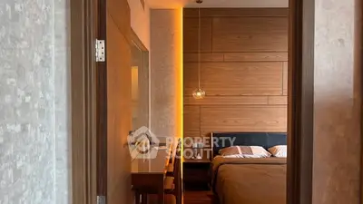 Luxurious bedroom with modern wooden paneling and ambient lighting, featuring a cozy workspace.