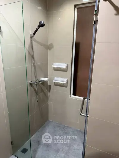 Modern bathroom with glass shower enclosure and sleek fixtures