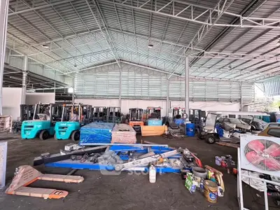 Spacious industrial warehouse with forklifts and equipment, ideal for logistics and storage solutions.