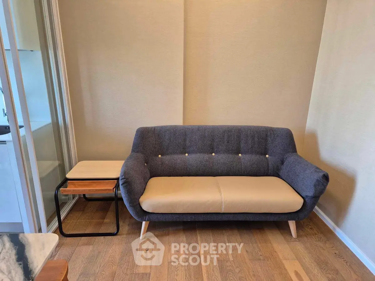 Modern living room with stylish sofa and wooden flooring, perfect for cozy relaxation.