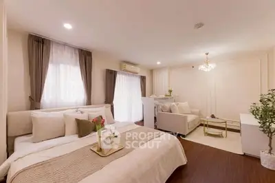 Luxurious bedroom with elegant decor and cozy seating area, perfect for relaxation.