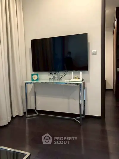 Modern living room with sleek TV setup and elegant console table.