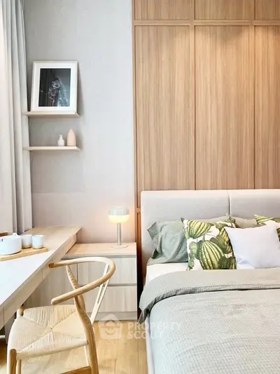 Modern bedroom with stylish decor and cozy ambiance, featuring wooden accents and elegant furnishings.