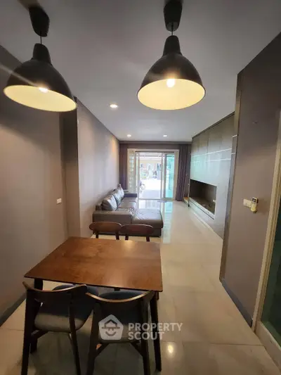 Modern living room with stylish lighting and cozy seating area, perfect for relaxation and entertainment.