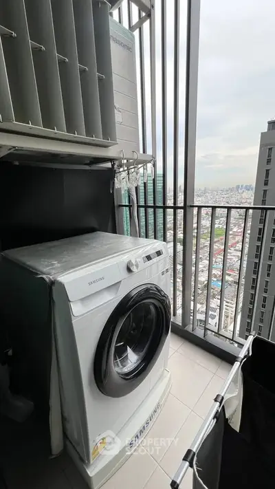 Modern balcony with washing machine and city view, perfect for urban living convenience.
