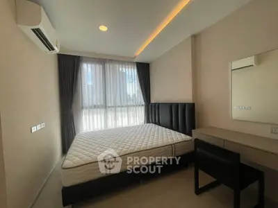 Modern bedroom with large window, stylish bed, and sleek furniture in a contemporary apartment.