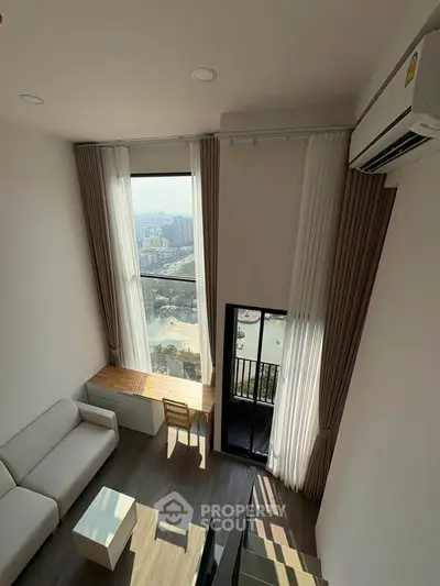 Modern high-rise apartment with stunning city view, featuring a cozy living area and large windows for natural light.