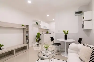 Modern living room with open kitchen, stylish furniture, and elegant decor in a bright apartment.